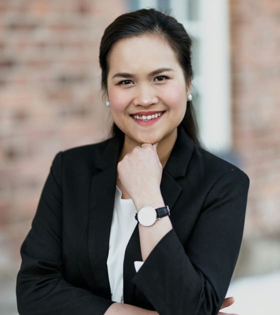 Smiling professional woman in business attire.